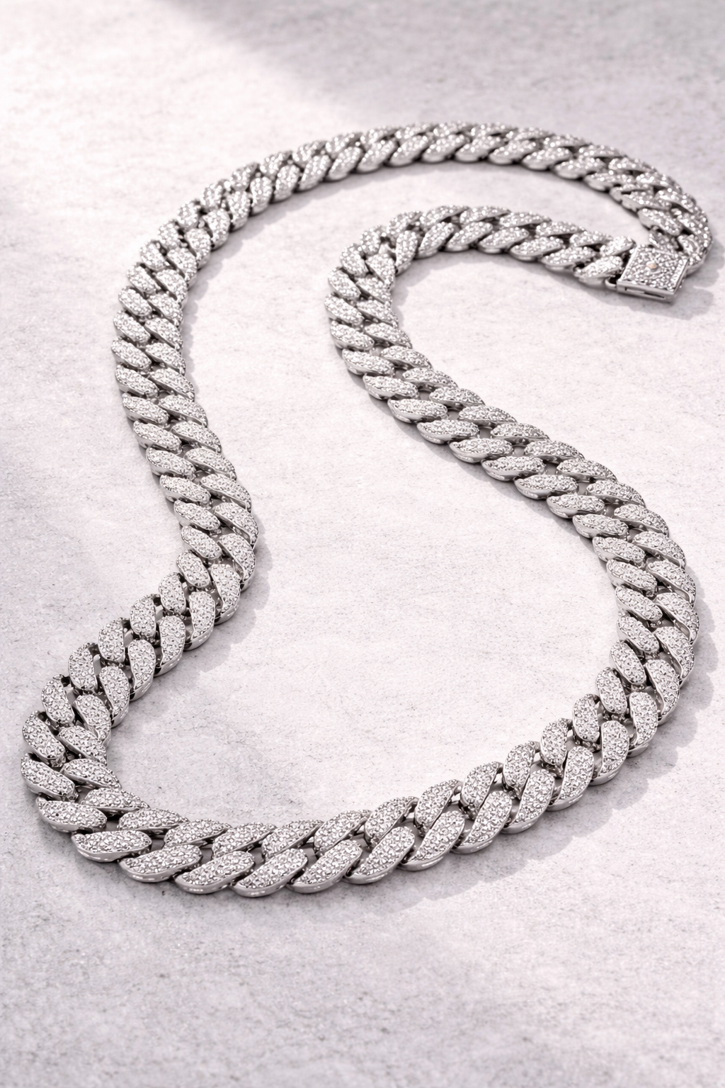 Sterling silver with rhodium, zig zag Cuban chain with cubic zirconia.
