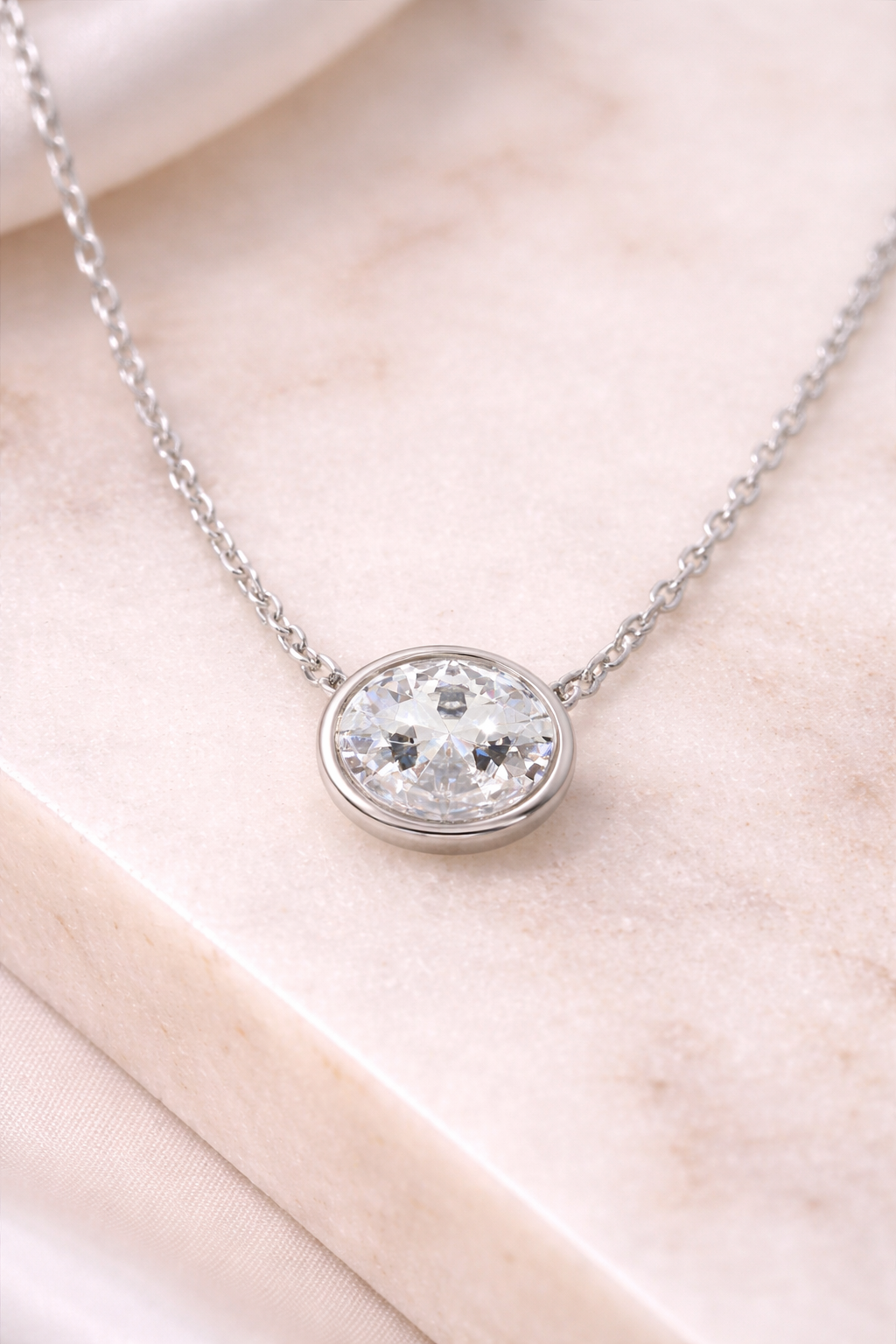 Sterling silver with rhodium, 9.5x12mm oval cubic zirconia necklace, 16″ + 2″ extension